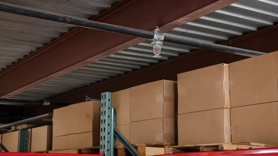 Representative AI-generated warehouse storage positioned close beneath a sprinkler